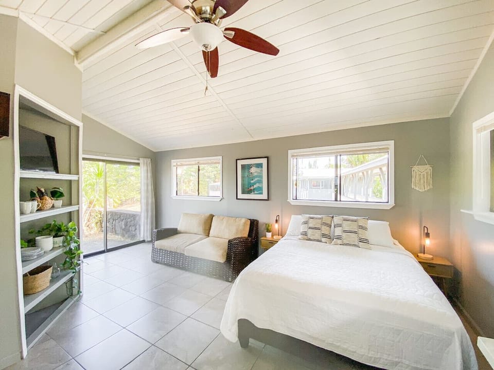 Cozy bedroom with a comfy seating area and natural light.