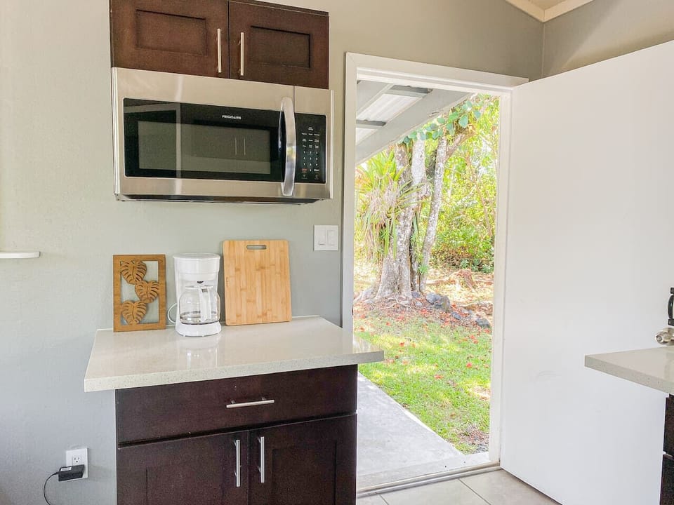Simple kitchen area with a clean design and a view of the outdoors.