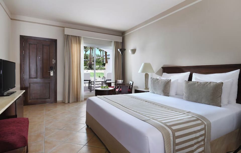 Unwind in crisp linens with garden views outside.