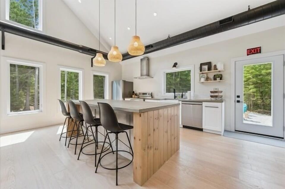 Vaulted ceilings, a wall of windows, and modern-rustic décor create a warm and welcoming space for families and groups.