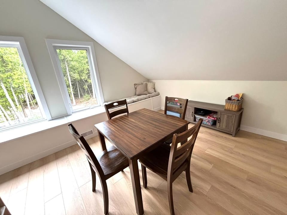 A perfect hideaway for quiet moments – enjoy board games, reading, or family fun in the cozy upstairs nook with forest-facing windows and a charming window seat.