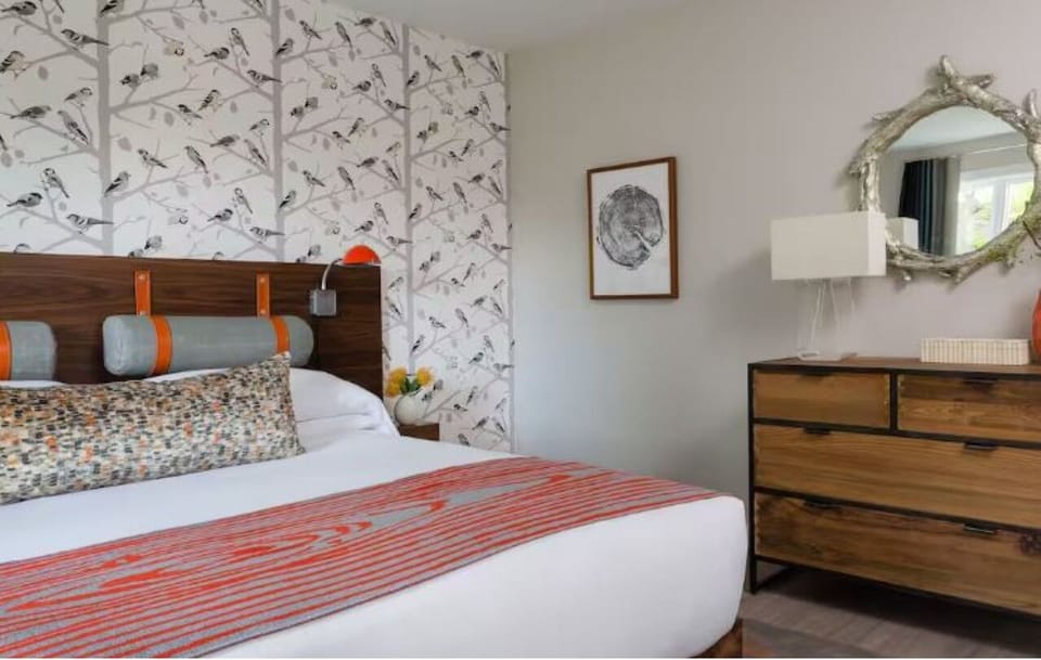Stretch out in a designer bedroom with warm textures and calm.