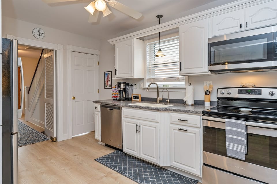 Wake up to coffee and convenience in this well-equipped kitchen featuring a dishwasher, updated fixtures, and natural light!