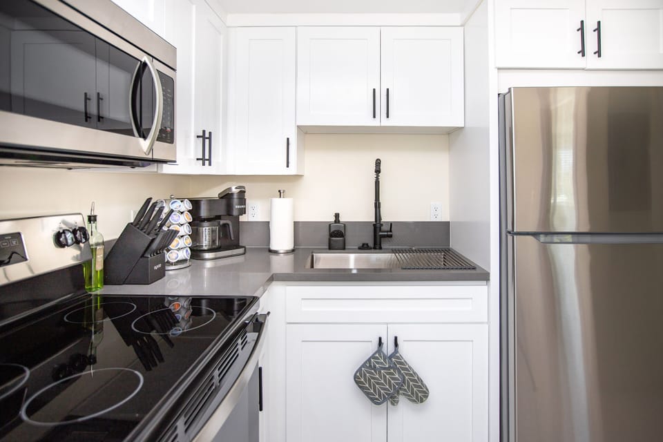 Clean kitchen with microwave and cooking essentials