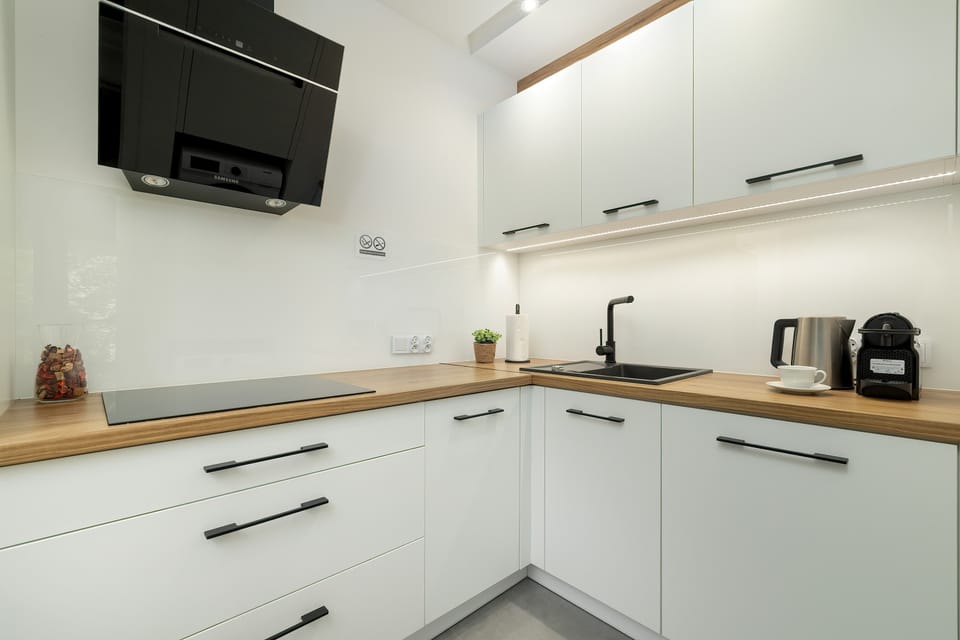 The sleek design of the kitchenette blending seamlessly with the living area.