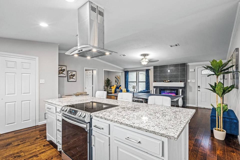 Feast your eyes on this culinary dream kitchen! Gleaming stainless steel appliances shimmer under recessed lighting, while top-of-the-line cookware hangs from sleek pot racks. Imagine whipping up gourmet meals with a chef's knife on gorgeous granite 