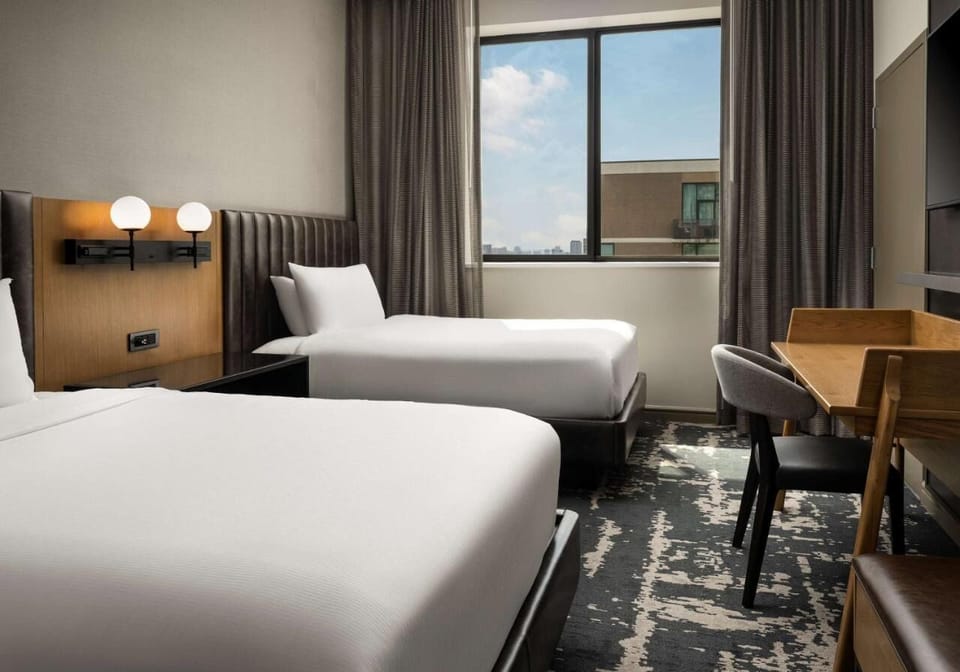Recharge together in a spacious twin room with city views.