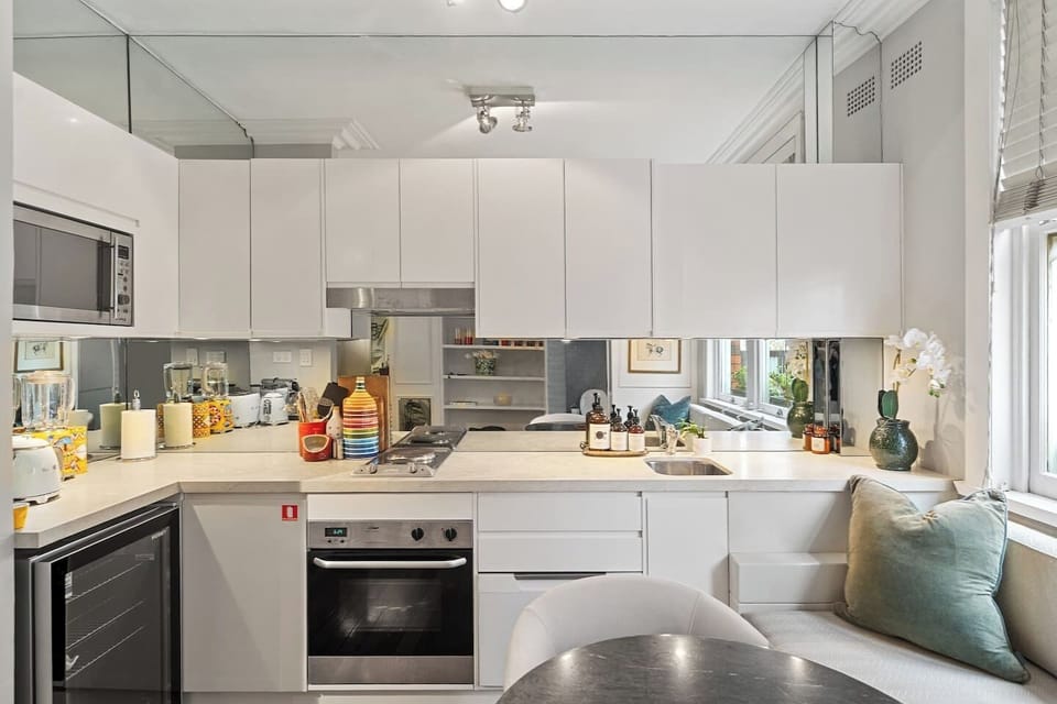 From sleek cabinetry to mirrored splashbacks, the kitchenette combines function with design, ideal for extended stays with everything from an oven to a dishwasher at hand.