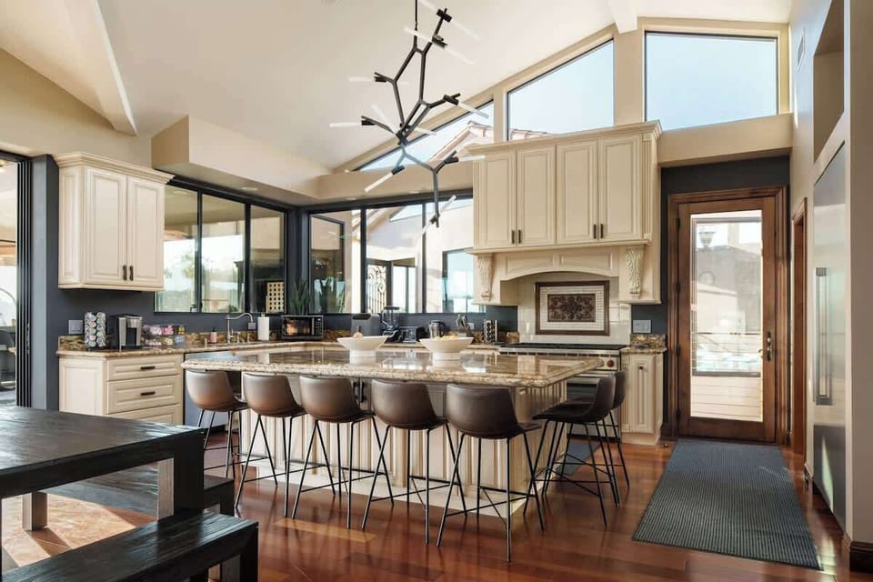 Cook, dine, and connect! This chef’s kitchen features modern appliances, a spacious island with seating for eight, and stunning mountain views to inspire your culinary creations.