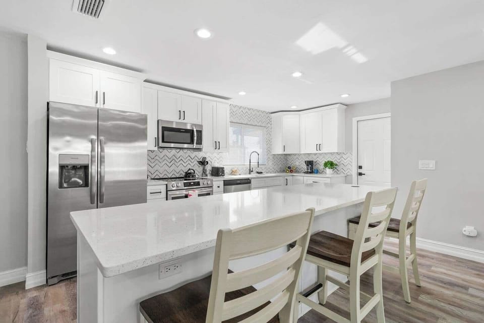 Another camera angel of the roomy kitchen island with plenty of seating, ideal for sharing meals and fun family conversations.