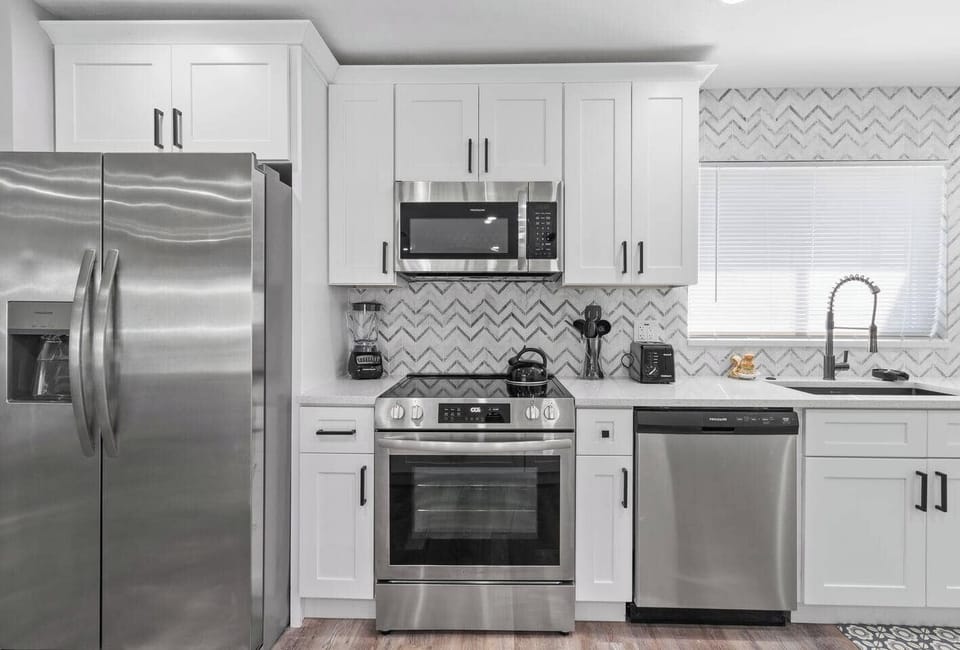 Enjoy a fully stocked kitchen with premium stainless steel appliances, ready for all your culinary needs.