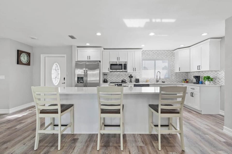 A roomy kitchen island with plenty of seating, ideal for sharing meals and lively conversation in the heart of the home.