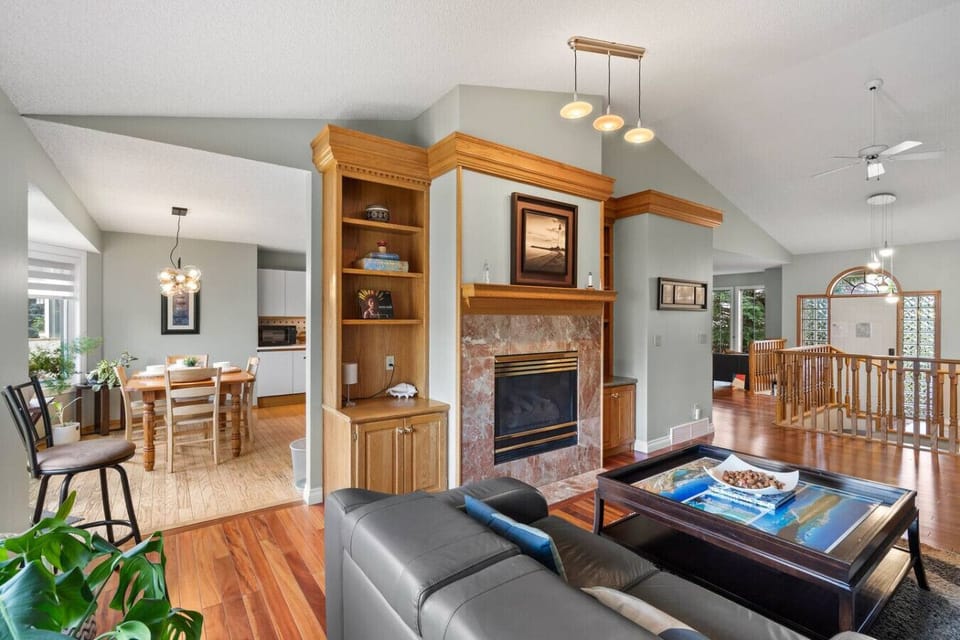 Living room on the main floor with a gas-lit fireplace,. Smart TV and cozy seating options.