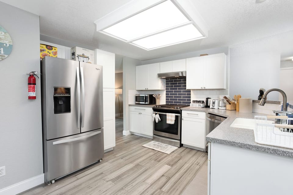 Kitchen with refrigerator, cooking range, oven, microwave, cookware, bakeware