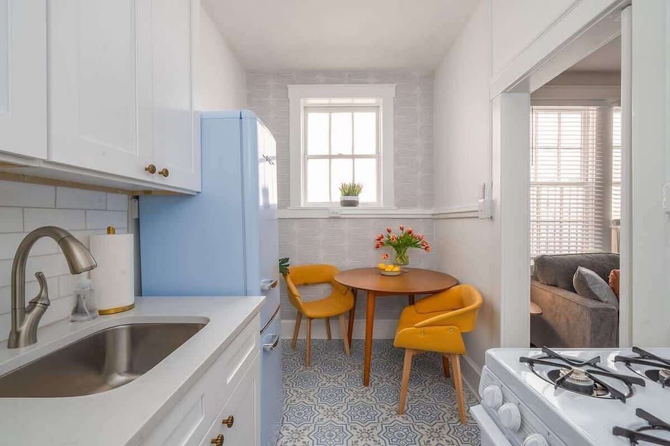 Enjoy coffee overlooking this cute retro kitchen with tons of natural sunlight!