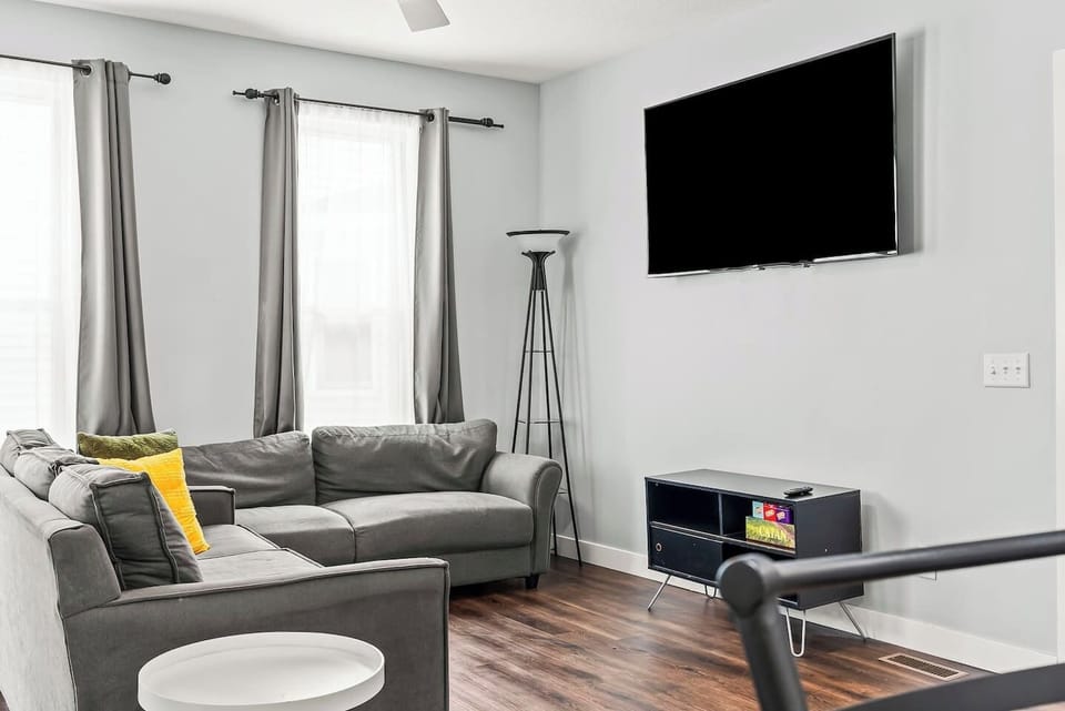 Spacious downtown Fort Wayne living room with stylish seating, hardwood floors, and a smart layout ideal for movie nights.