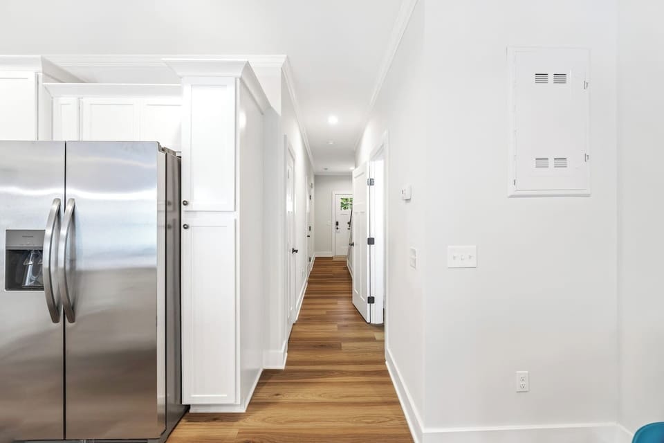 A well-designed hallway connects living spaces with bedrooms and baths — all in a bright, open flow.