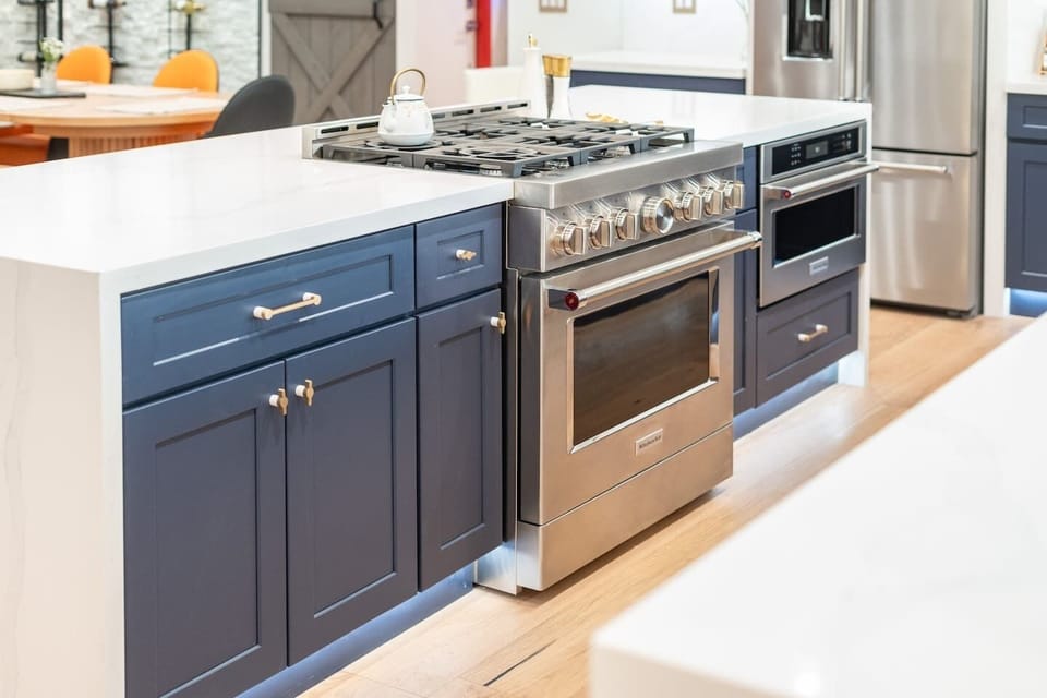 A kitchen that blends bold luxury with homey charm. From the sleek island and gold hardware to the wall-to-wall windows—this space is made for memorable moments.