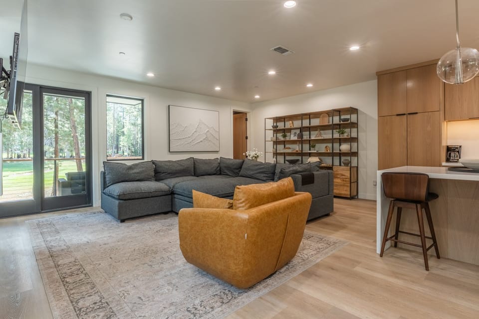 Living Room, Linear Gas Fireplace , Arm Chair, 77 Inch Smart TV, Deck With Patio Furniture and Gas BBQ, Half Bathroom