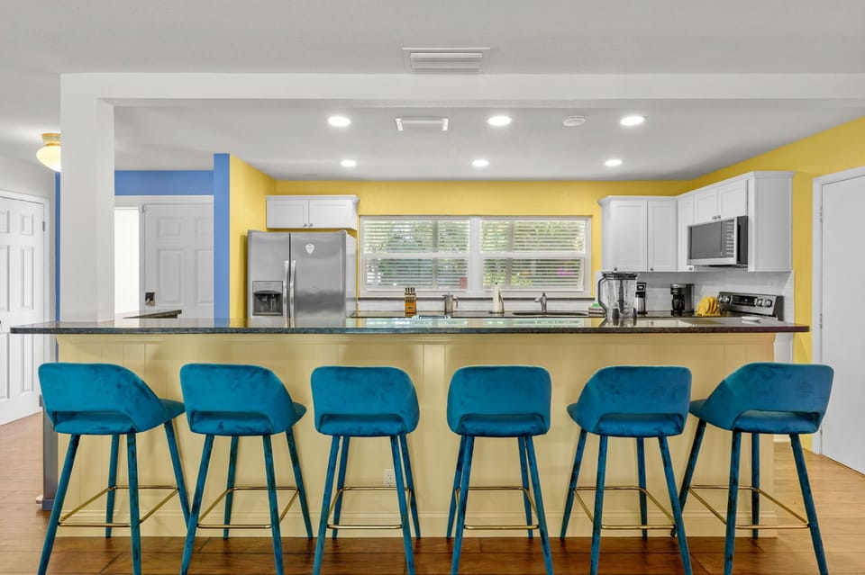Our fully stocked kitchen features a spacious island with high seating—perfect for casual meals, morning coffee, or chatting with the chef.