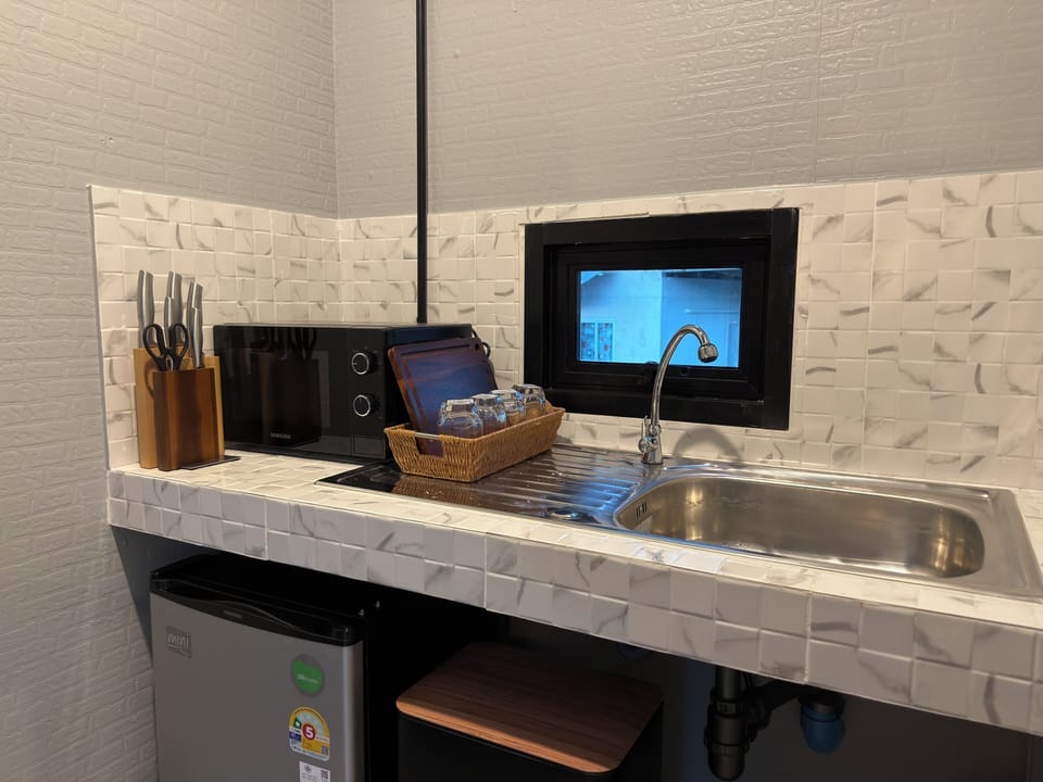 You prepare snacks and drinks in your compact kitchen for a cozy day.