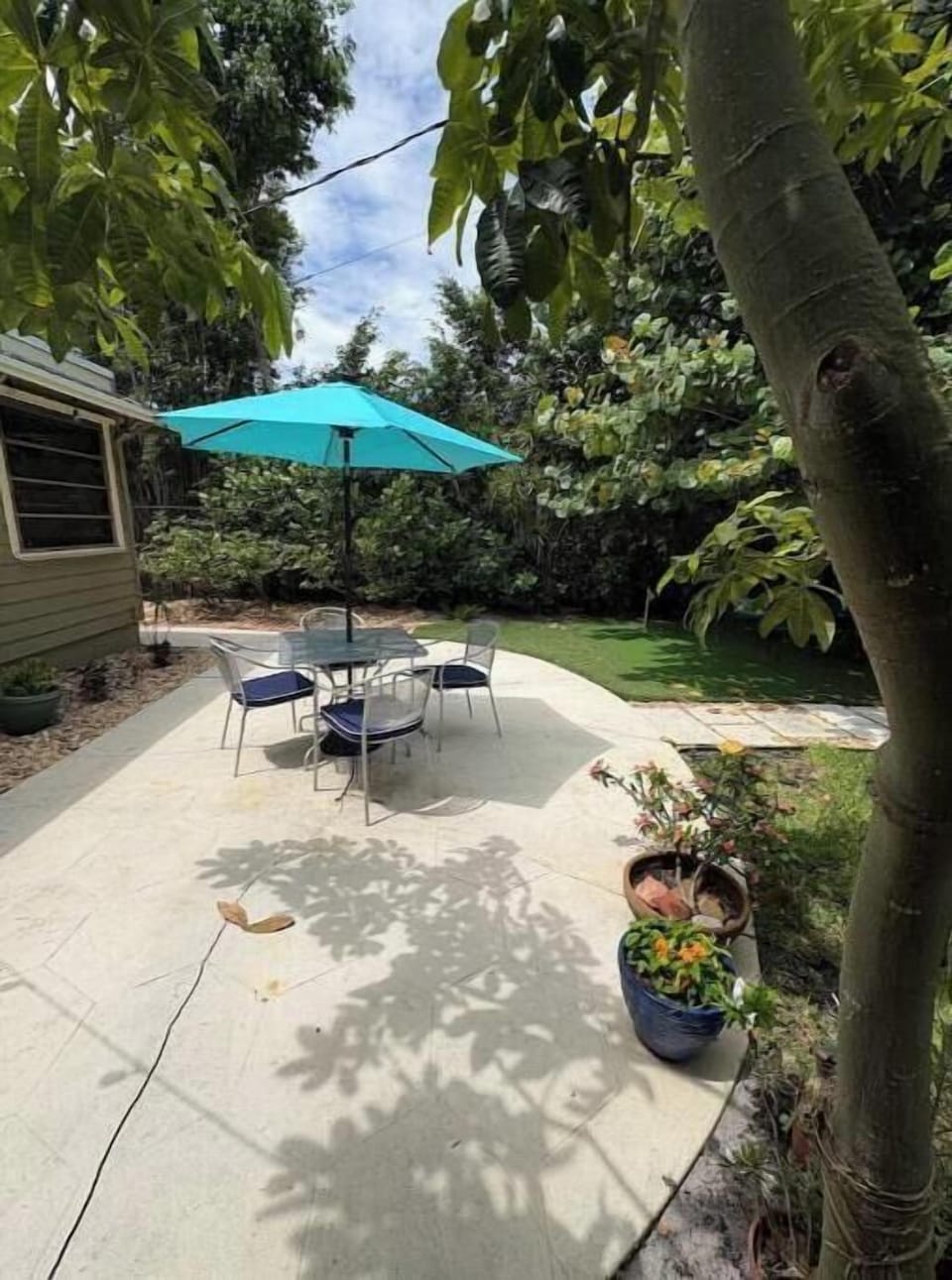 Dining table with umbrella perfect for dining alfresco.