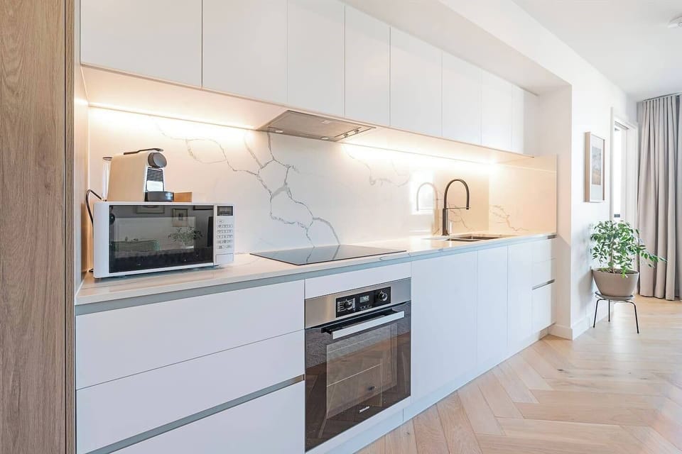 Prepare meals with ease in the fully equipped kitchen with a full oven, induction cooktop, Nespresso machine, microwave, fridge and dishwasher.