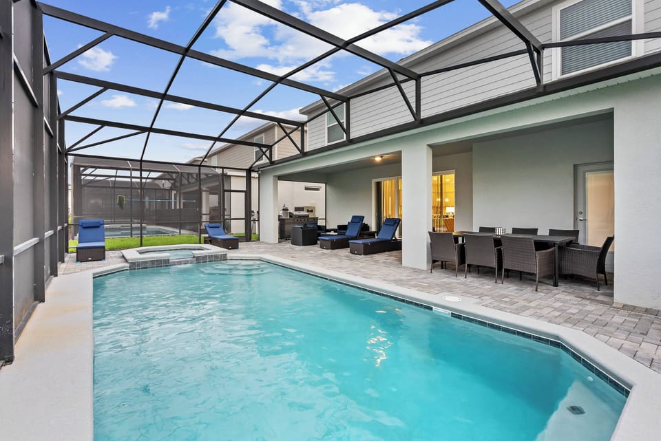 Step outside to discover your private oasis featuring a sparkling pool surrounded by an elegant stone patio. With comfortable seating and a clear view of the sky, this outdoor space invites relaxation and sun-soaked afternoons.