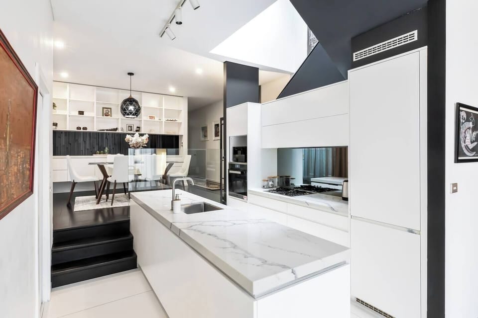 Prepare your favourites in the designer kitchen equipped with a marble-look island, gas stove, oven, microwave, dishwasher, and coffee makers, including Nespresso and French press.