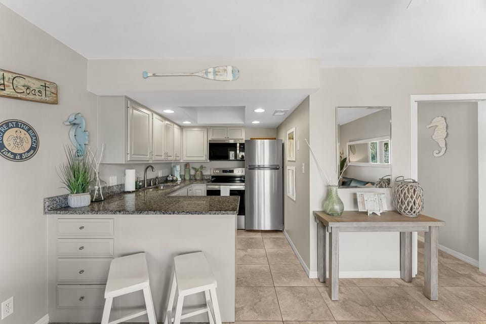 Fully equipped kitchen with modern appliances, dishwasher, and ice maker