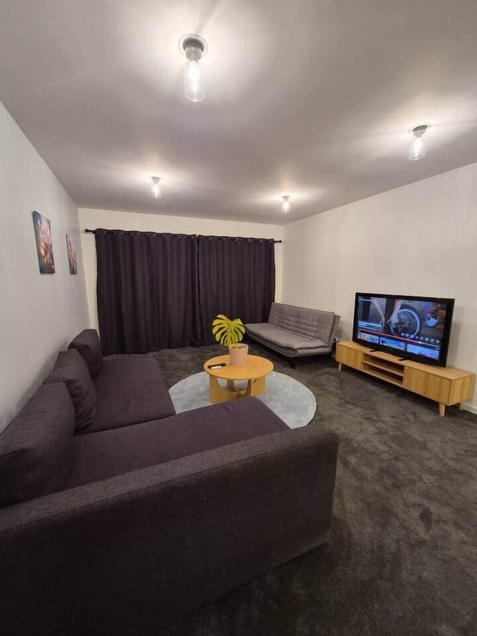 Light grey cough is also a double bed - enjoy the 55 inch TV with chromocast 