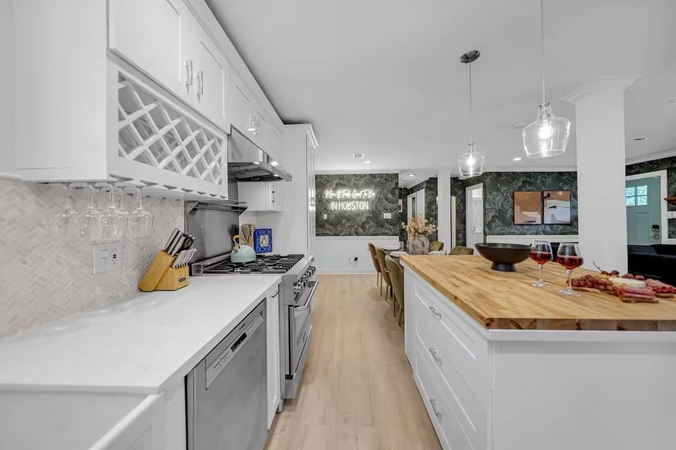 Modern kitchen with full appliances, island seating, and open layout.