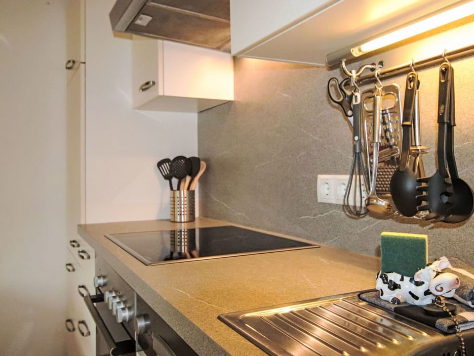 Kitchen, Countertop, Interior Design, Kitchen Appliance, Lighting, Light Fixture, Kitchen Stove, Cabinetry, Home Appliance, Plumbing Fixture