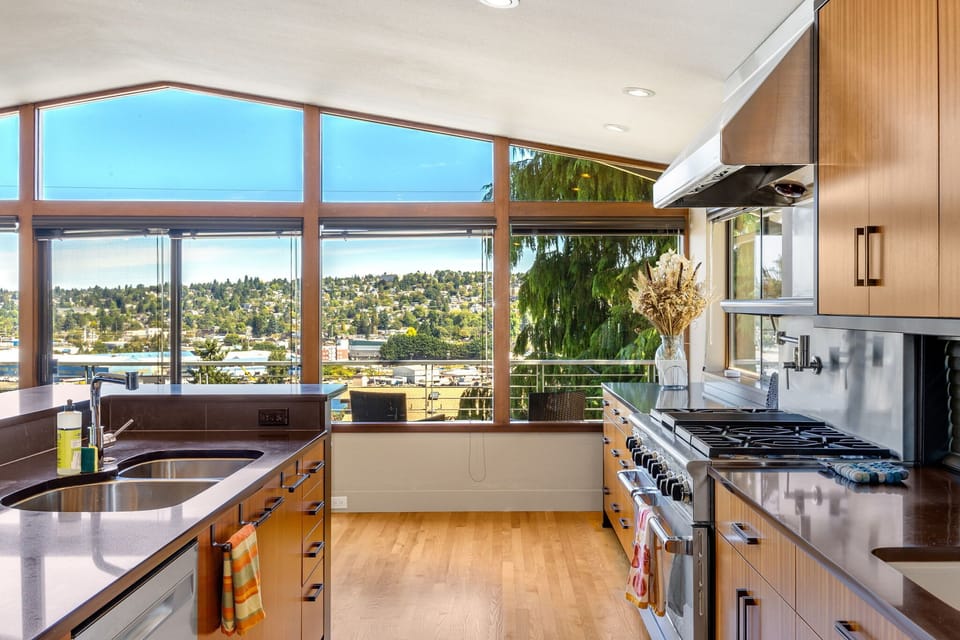 Light-filled living space with large windows and a cozy atmosphere on the main level of the house.