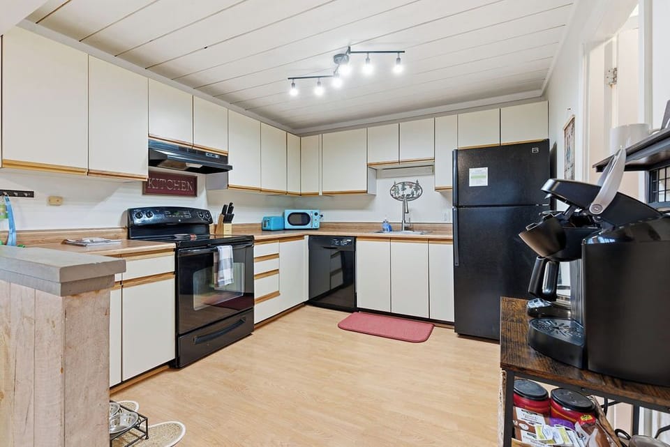Full kitchen with stove, refrigerator, dishwasher. 