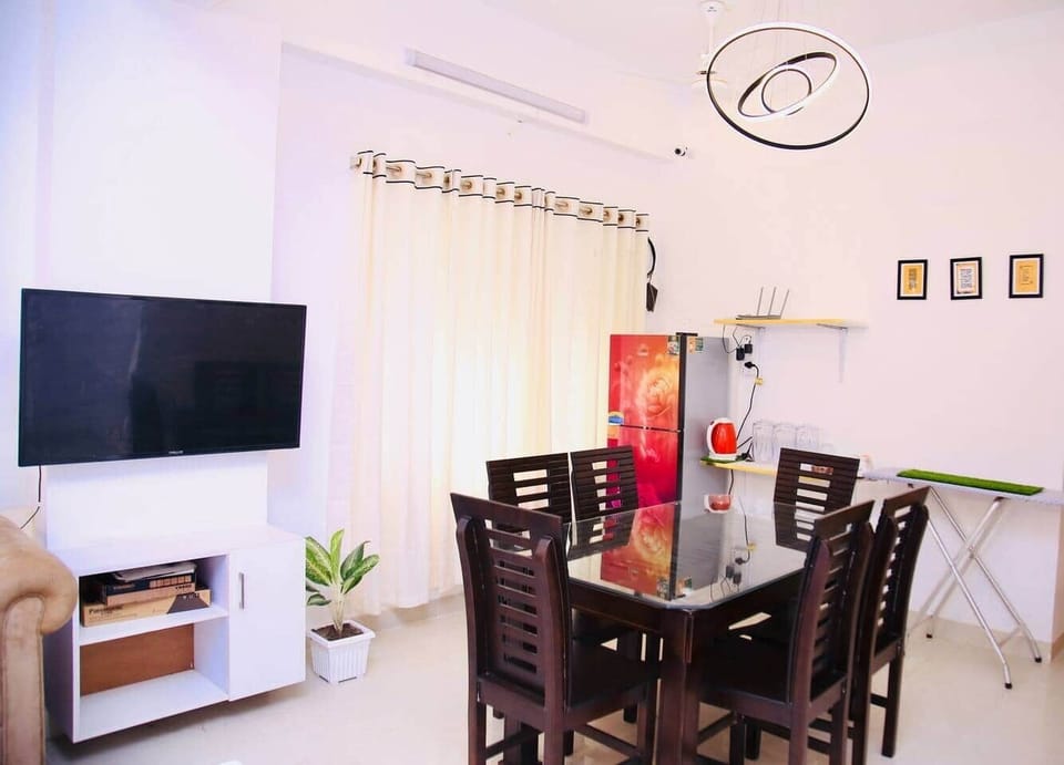 "Multi-purpose dining area with fridge, iron table