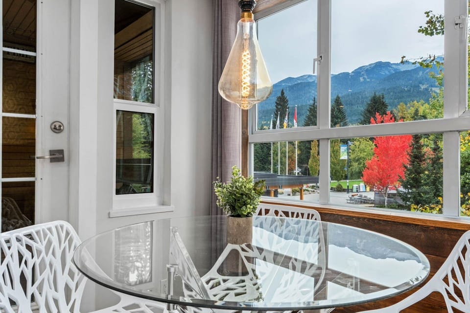 Bright natural light fills this inviting living room with views of Whistler Village below.