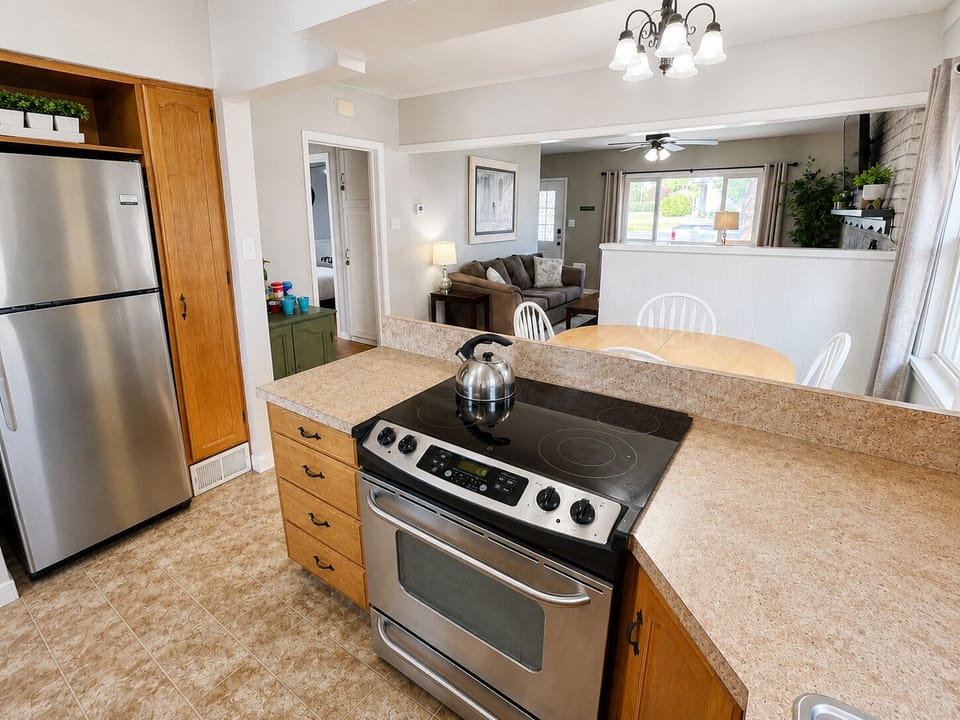 Fully stocked kitchen opens to dining and living room for easy gathering