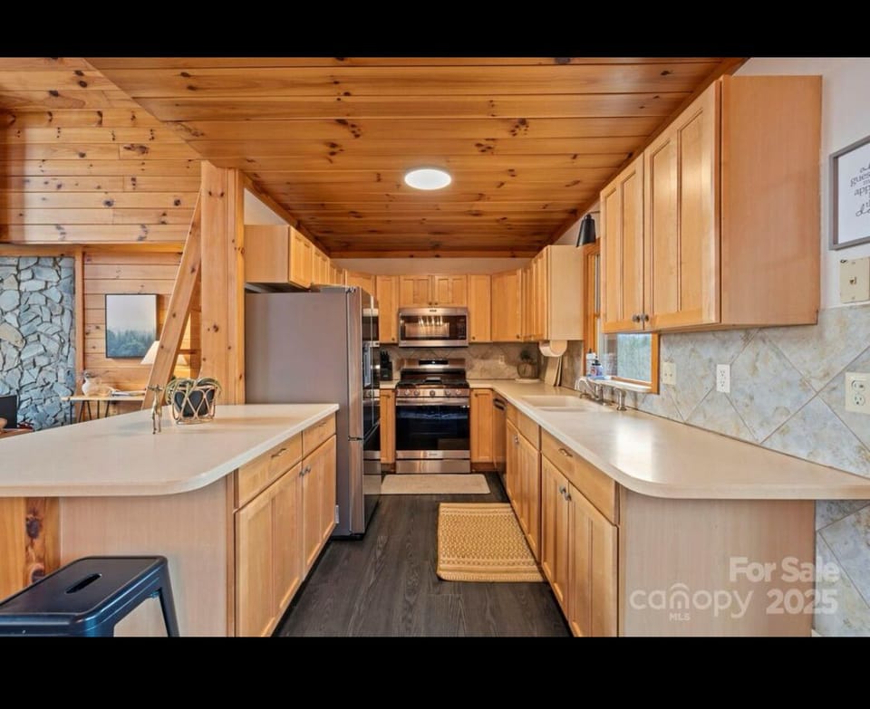Kitchen with gas stove and electric  oven living area