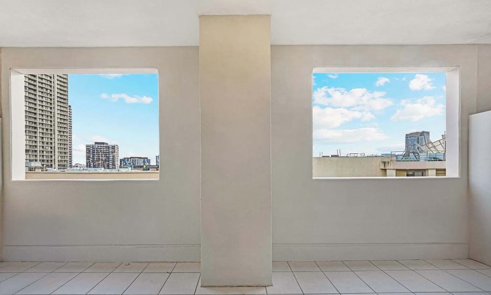 Building common area with large windows showcasing skyline views.
