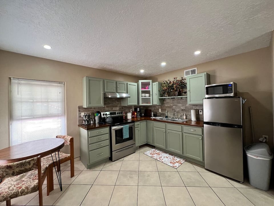 Fully Stocked Kitchen - Cabinet Space, Counter Space, Spices, Seating Area, Modern Appliances: Oven/Stovetop, Microwave, Fridge, and Coffee Machine