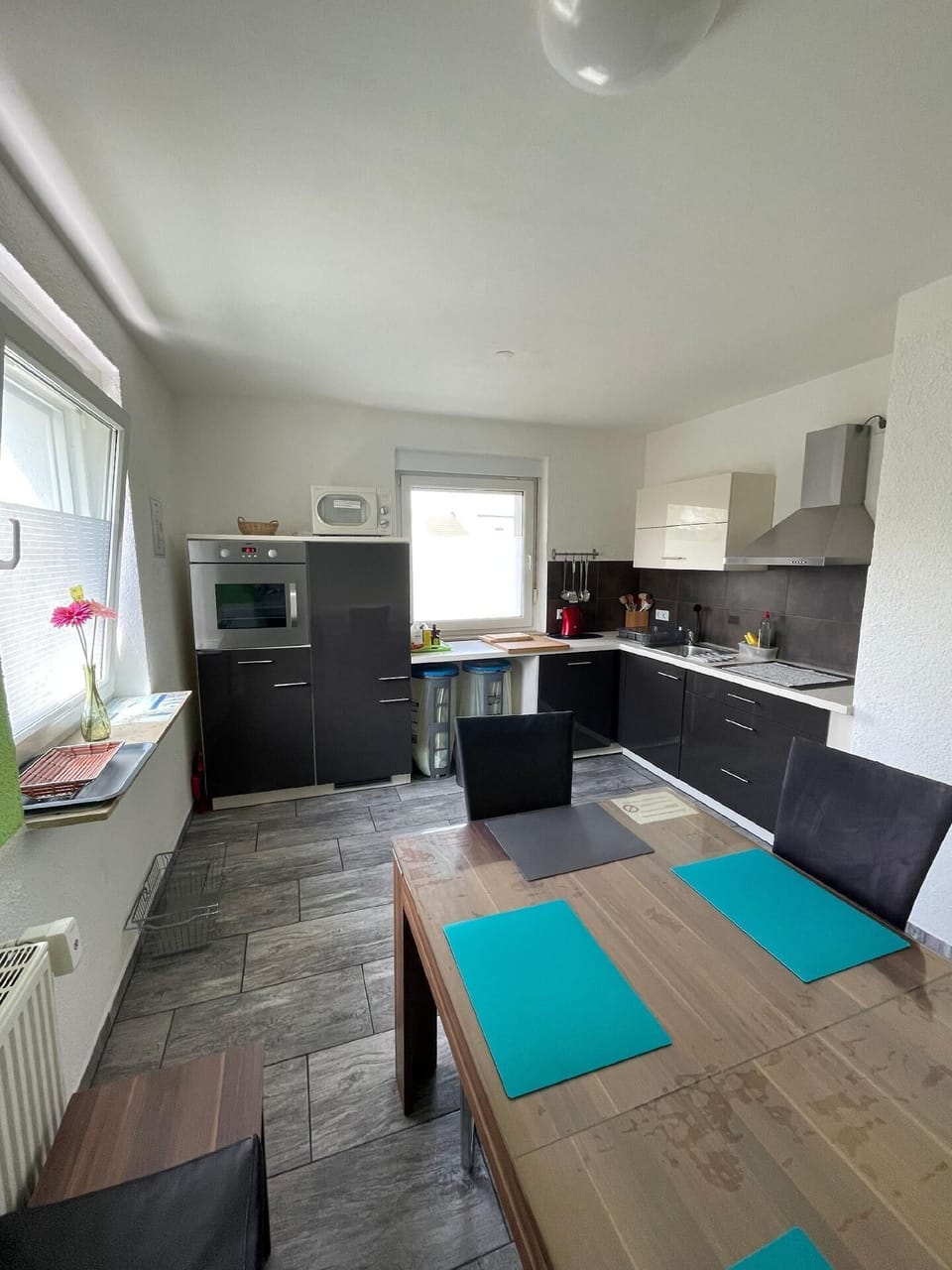 Modern kitchen with dining table and full equipment