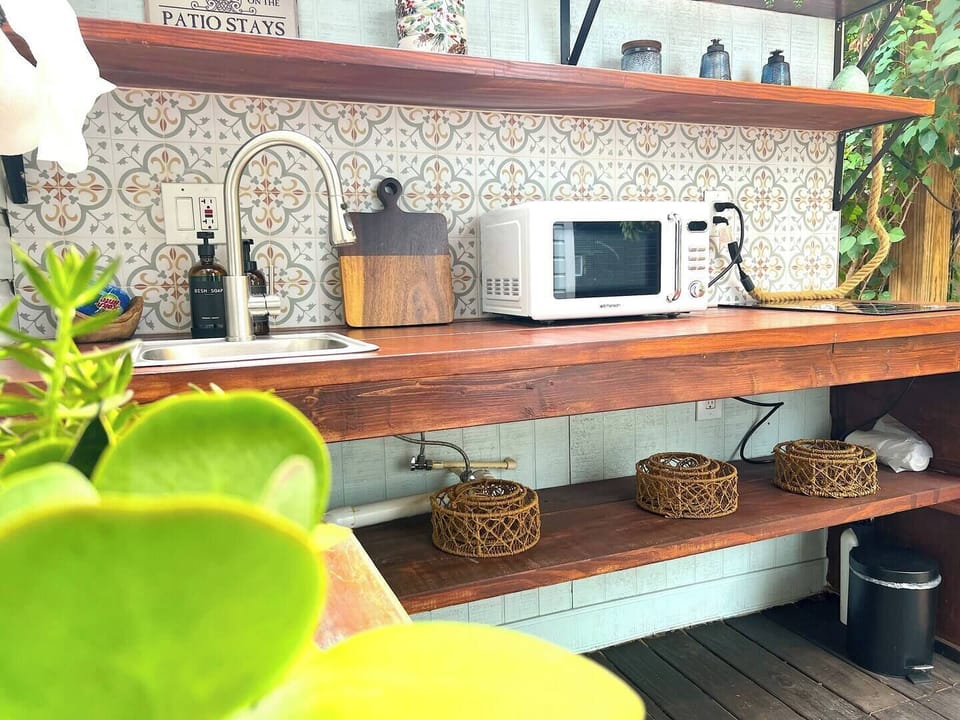 Prepare a light breakfast or late-night snack side by side in this charming outdoor kitchen. With the scent of fresh herbs in the air and vines curling around you, it’s the perfect setting for simple moments and shared meals together.
