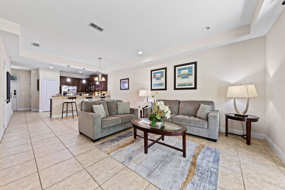 Dining area for six under warm lighting, just off the kitchen for easy gatherings.