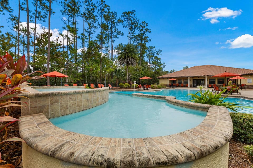 Bright, open pool deck with lounge chairs and umbrellas, offering a true vacation vibe.