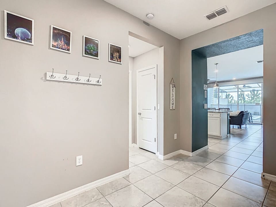Modern hallway with coat storage and direct kitchen entry.