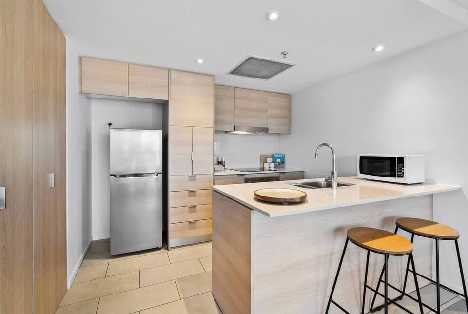 Prepare simple meals with the full-size oven, ceramic cooktop, and a thoughtful selection of cooking essentials in the well-equipped kitchen.