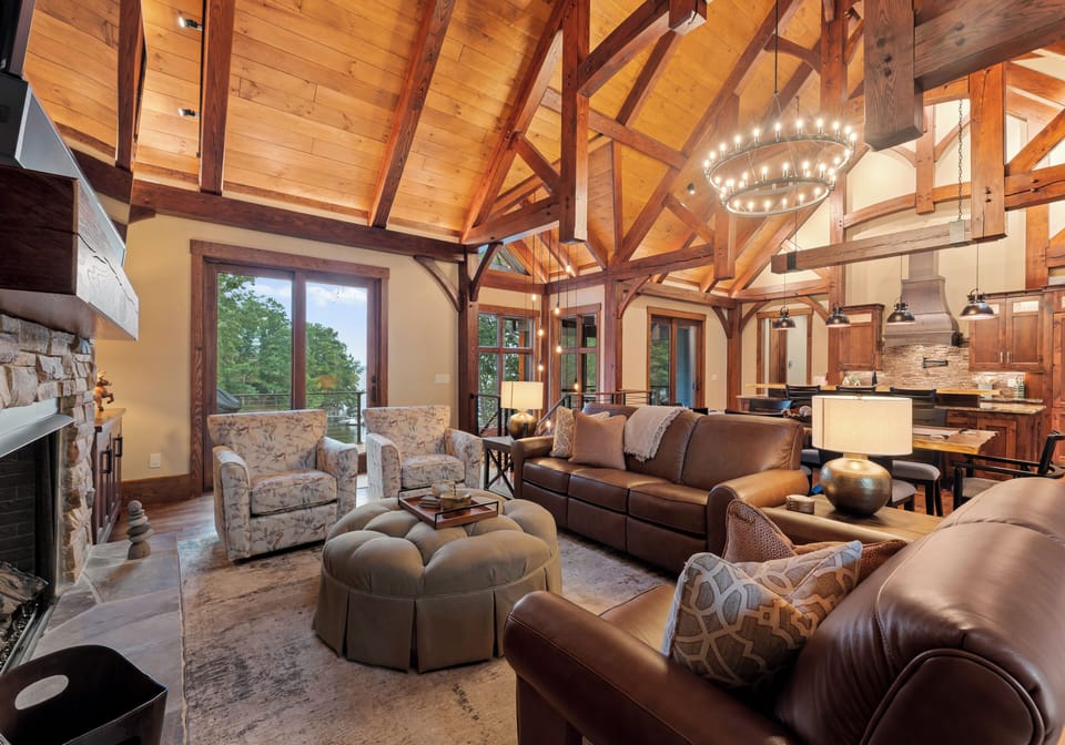 Main level in living room with plenty of seating options and lake views!