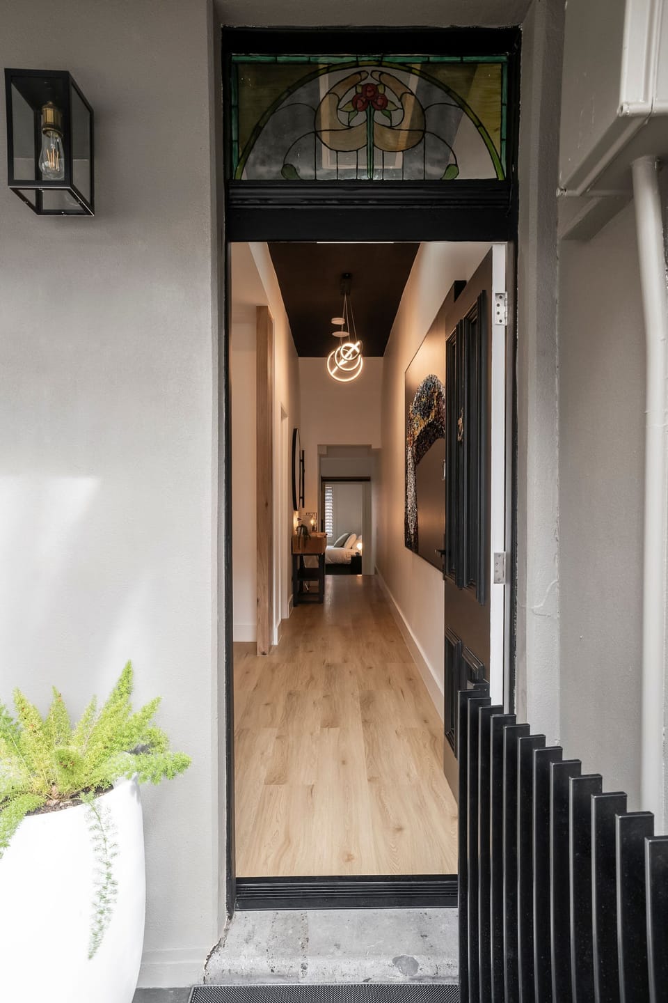 HALL: Enter the stylishly renovated hall with feature lighting and artwork to enjoy a modern home in the heart of Carlton.