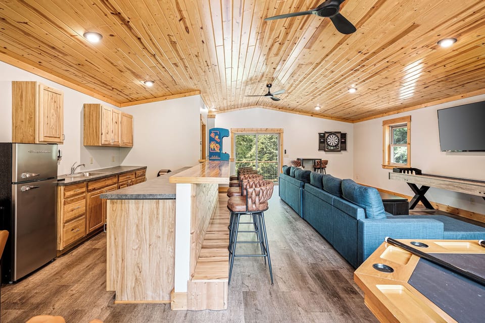 Game Room:  The game room is located on the lower level and it has plenty of games for the family to enjoy including a wet bar, margarita maker, ice machine, 3 televisions  and a half bathroom